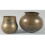 A LARGE AND HEAVY BRASS GLOBULAR BOWL, together with another inscribed brass bowl, larger approx.