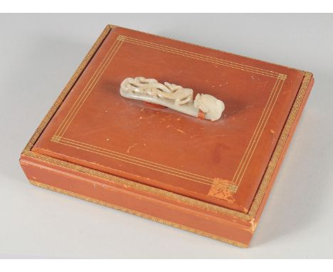 A CHINESE SQUARE FORM LIDDED BOX WITH MOUNTED CARVED JADE BELT HOOK HANDLE, the lid opening to reveal four compartments, box 
