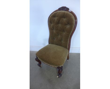 A Victorian walnut button back nursing chair
