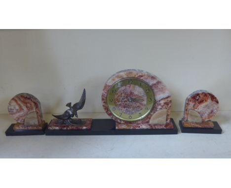 An Art Deco three piece clock garniture, Arabic numerals to champagne covered chapter ring, sculptural figure of swooping bir