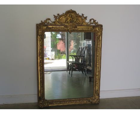 A large 19th century giltwood mirror, scrolling foliate design to top with cherubs, foliate to surround - 153cm x 103cm