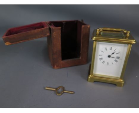 A brass carriage clock with travel case and key - Height 12cm - clean working order