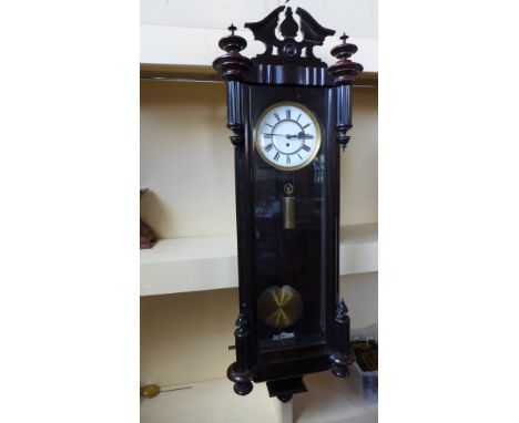 A 19th century ebonised Vienna single weight wall clock 120cm high with weight pendulum and key - in working order