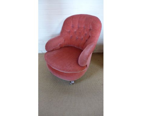 A Victorian button back armchair with replacement casters
