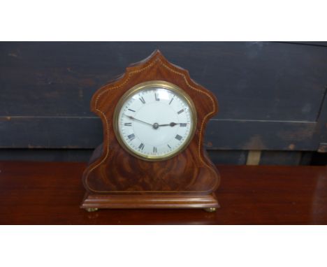 A flamed mahogany and strung inlaid cased Art Deco clock with Roman numerals to white enamel dial with Arabic numerals at 1/4