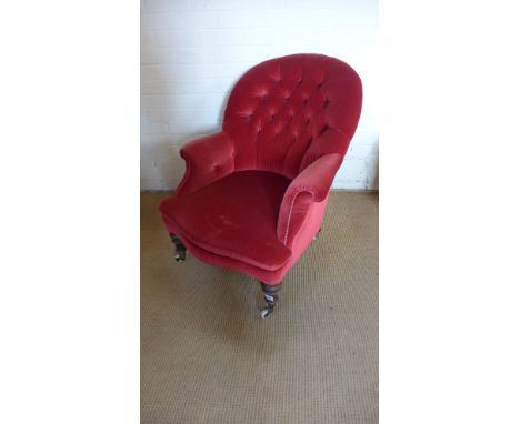 A Victorian button back armchair