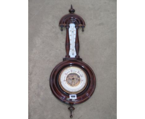 An aneroid barometer with thermometer