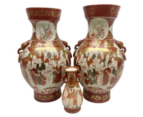 Pair of Japanese Meiji period Kutani vases, of twin handled baluster form finely painted with dense panels of figures and flo