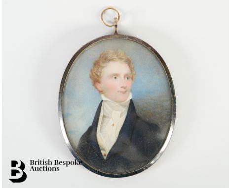 A fine George III portrait miniature on ivory of a gentleman dressed in a blue frock coat with cream waistcoat and stock, the