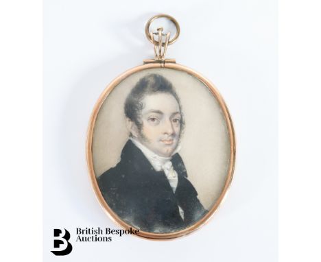A George III portrait miniature on ivory of a gentleman dressed in a black frock coat with cream stock, in the manner of Andr