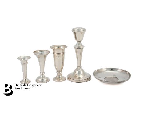 A travelling candlestick, Birmingham assay mark dated 1970 mm W.A (weighted) 145.5 gms; three silver bud vases (two filled) a