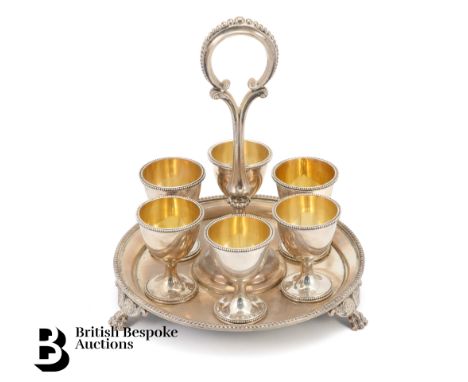 Victorian silver egg cup stand. The stand and four egg cups are London dated 1880 and two egg cups are London dated 1885, all