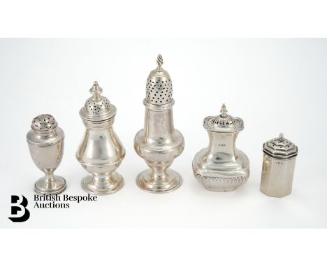 Four silver pepperette with Birmingham, Chester and London hallmarks (rubbed) and a silver sugar caster (marks rubbed), 256.8
