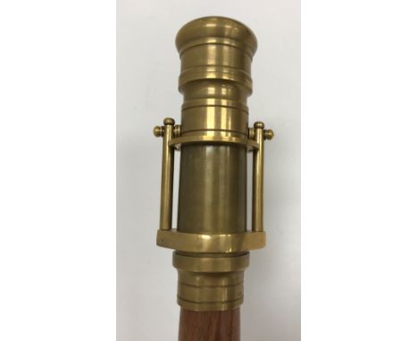 A modern walking stick with brass telescope finial