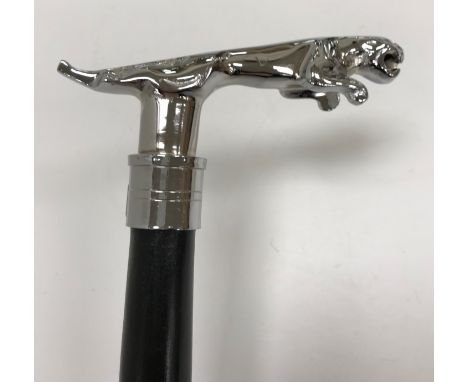 A modern walking stick with Jaguar style chromed handle to top