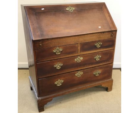 A 19th Century oak bureau, the fall front enclosing a basic fitted interior, with well over two short and two long drawers wi