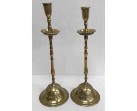 A pair of late 18th / early 19th Century bell metal travelling candlesticks, the plain holders with dished drip trays on bobb