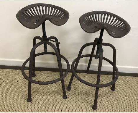 A pair of modern stools as tractor seats of adjustable height, base 46 cm diameter 