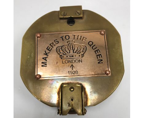 A modern heavy brass compass bearing copper plaque inscribed "Makers to The Queen", 9 cm wide x 4 cm high