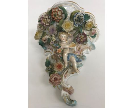 A collection of Continental china wares to include a pair of Schierholtz cherub and floral encrusted wall brackets 18 cm high