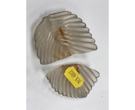 A pair of Chinese carved agate leaf bowls or dishes, with scroll work decorated wooden stands, 8.2 cm x 5.6 cm x approx 2 cm 