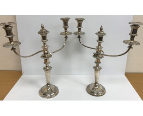 A pair of 20th Century plated two branch three light table candelabra with beaded decoration, raised on circular feet, 46 cm 