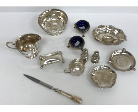 A collection of silver wares to include a pair of cauldron salts on three hoof feet with blue glass liners (by T H Hazlewood 