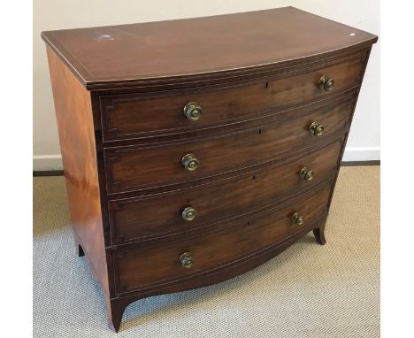 A Regency mahogany bow fronted chest of four long graduated drawers with moulded edges and brass knob handles, raised on swep