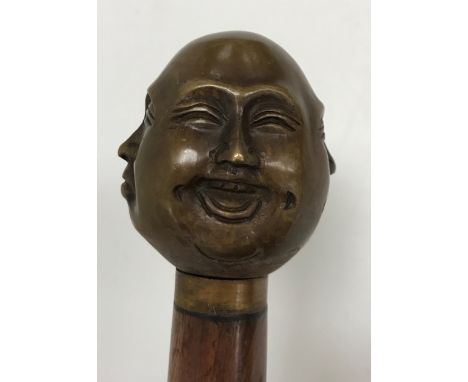 A modern walking stick with Buddha head finial