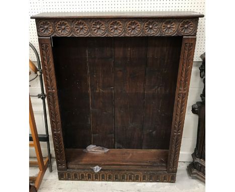 A Victorian carved oak Gothic Revival corner cabinet, the upper section with gadrooned, dragon scale and floral medallion dec