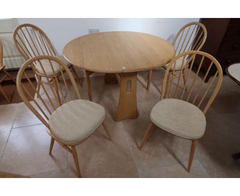 An Ercol drop leaf table 106cm wide x 120cm tall with four matching Ercol chairs