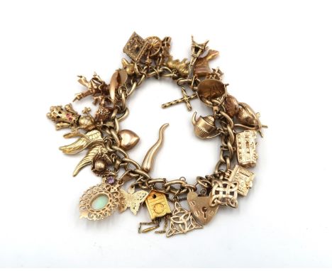 A 9ct gold charm bracelet with 31 charms to include: Nefertiti 14ct, Gondola 18ct, Heart 9ct, Cuckoo Clock 9ct, Butterfly 10c