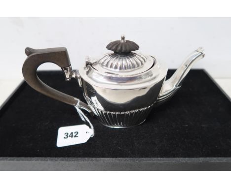An Edwardian silver bachelor's teapot, with gadrooned decoration, and ebony angular auricular handle and finial, Barker Broth
