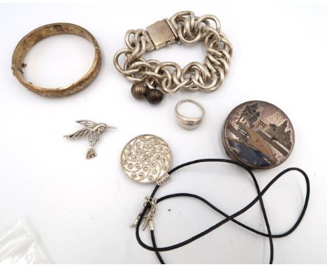 A group of silver jewellery comprising an oversized curb link bracelet, a pair of earrings of comed form, a pendant, kingfish