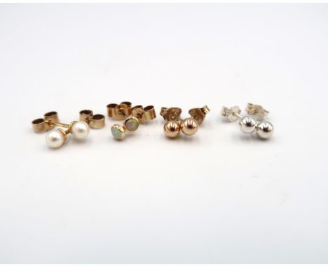 Four pairs of stud earrings - a pair of 9ct yellow gold opal studs - approx weight 0.6 grams - a pair of 18ct yellow gold pea