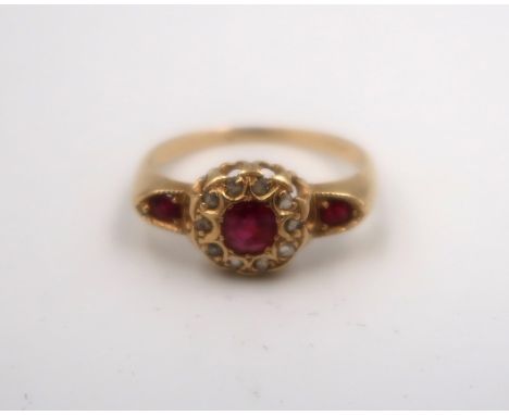 An 18ct gold ruby and rose cut diamond cluster dress ring. Size M 1/2. Weight 2.56 grams