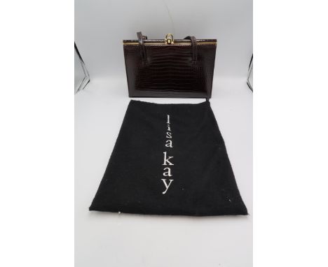 A vintage Elbief patent chocolate brown crocodile hand bag of classic form, 26.5 by 19 by 7.5cm deep.