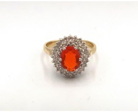 An 18ct yellow gold fire opal and diamond cluster ring, fire opal is a good colour, bright and lively, head size approx 14mm 