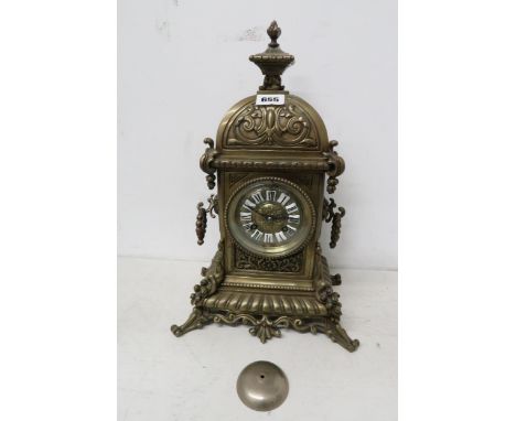 A brass mantle clock striking on a bell, 36cm high, the nut is missing which holds the bell in place, missing pendulum, with 