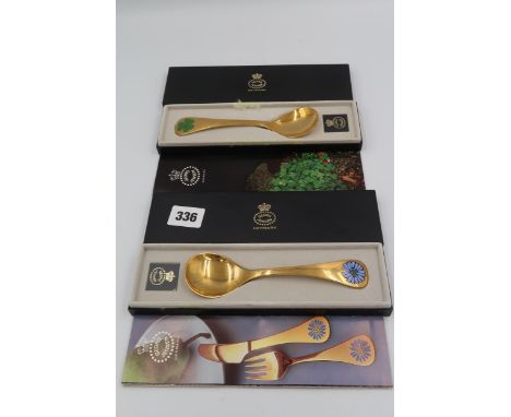 Two Georg Jenson silver and enamel year spoons for 1979 and 1980, complete with original boxes.
