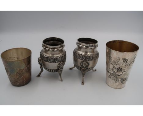 A pair of white metal, likely Continental 800 silver salts, of tall cauldron form raised on three goat legs with mask finials