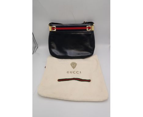 A vintage early 1980's Gucci handbag, in navy blue with red and blue striped trim to the top, Gucci buckle detailing and shou