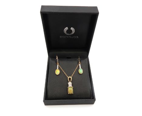 A 9ct gold, opal and diamond set pendant the single opal with fire opal tones, of approximately 8.8 by 6.8 by 4.7mm deep, in 