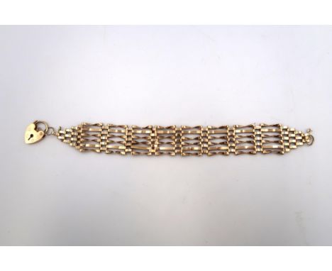 A 9ct gold six bar gate link bracelet with heart shaped padlock clasp, graduated to each end, 18cm long, total weight 12.5g.