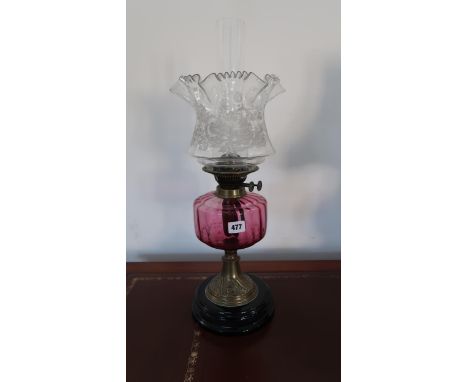 A 19th century oil lamp with a cranberry base and etched shade, 50cm tall, in good condition