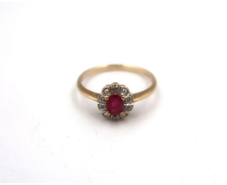 A 9ct gold oval ruby and diamond cluster ring. Size R. Weight 2.0 gramsGood condition