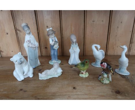 Seven Lladro figures and two Beswick bird figures