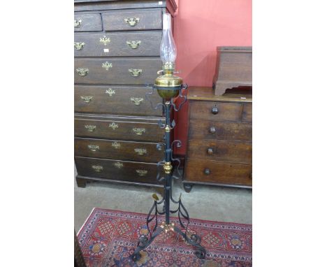 A Victorian Aesthetic Movement brass, copper and wrought iron floor standing oil lamp 