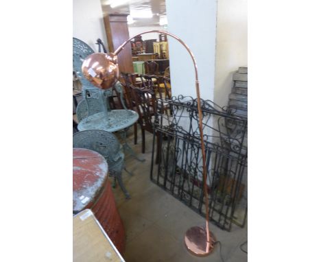 A copper effect arc standard lamp 