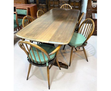 An Ercol period style dining suite in dark oak comprising rectangular refectory table,  6 (4 + 2) chairs, and Welsh dresser w